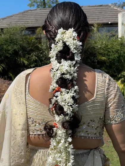 A detailed shot of the stunning floral braid, a perfect hairstyle for a traditional wedding function.
