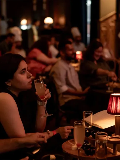 A guest enjoys a cocktail during our Ratatouille screening. Our experiences always include themed alcoholic and non-alcoholic drinks, ensuring every part of your evening, from the first sip to the last bite, is part of the cinematic story.