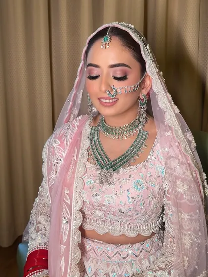 With eyes closed, you can appreciate the soft blend of pink and shimmer on the lids. This is a perfect example of a romantic and dreamy bridal eye makeup look.