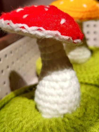 A close-up of the red mushroom, showing the stem and cap detail.