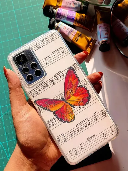 Here, I combined two of my favorite things: butterflies and music. This beautiful monarch butterfly is painted over a background of handwritten musical notes, creating a unique and artistic phone case insert.