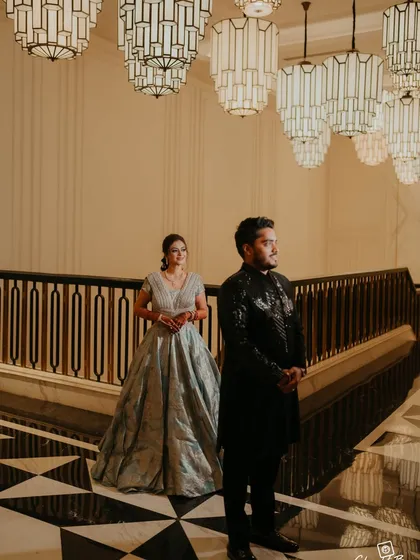 A candid shot of the couple in the grand lobby of the Fairmont Mumbai, with its stunning Art Deco chandeliers, before their Sangeet.