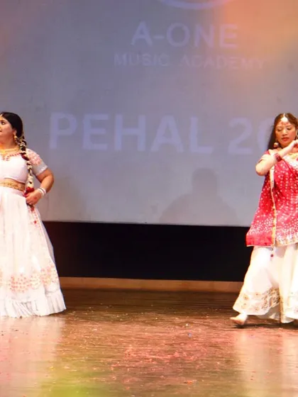 Dance is for everyone. Here, two of our adult students perform a graceful Kathak piece on stage at 'Pehal'. We welcome learners of all ages to explore their passion for dance.