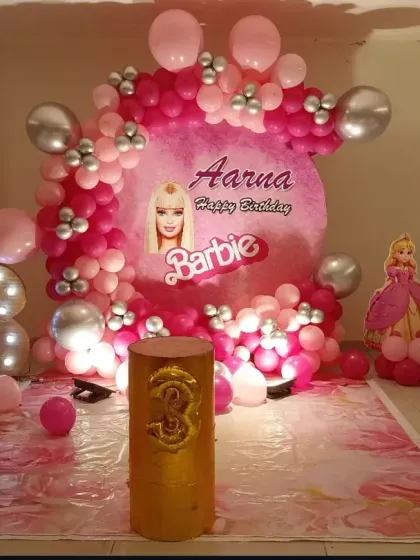 A vibrant Barbie-themed party for a 3rd birthday. This decoration features a custom circular backdrop with the birthday girl's name, multiple shades of pink balloons, Barbie cutouts, and a large foil "3" balloon.