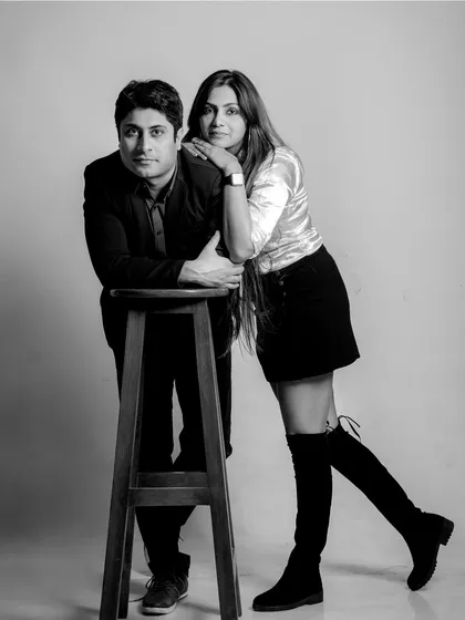 A stylish, posed black and white studio portrait. This showcases a more classic and formal side of couple photography, with a touch of old-school glamour.