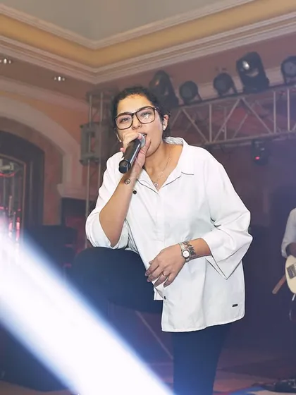 Dhruvi owning the stage during a performance for a corporate client. Our job is to elevate the event's atmosphere and leave a lasting impression.