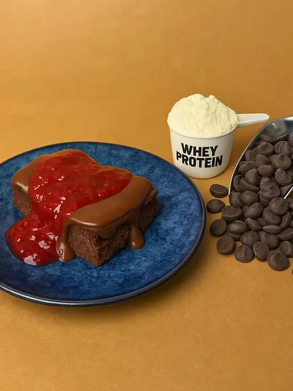This is how I pack 18g of protein into a dessert. My Chocolate Berry cake bar is made with real whey protein and topped with a rich chocolate ganache and berry compote. It's the perfect zero-sugar, grain-free treat to help you meet your fitness goals.