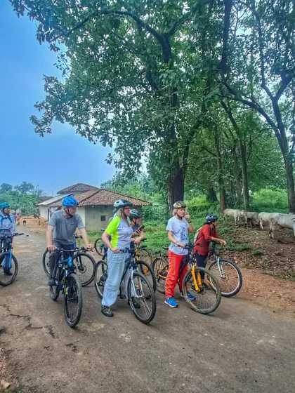 A group of riders pauses on a quiet road in the Kanha forest buffer zone. The tour is done at a relaxed pace, with plenty of time to stop, chat, and enjoy the peaceful environment.
