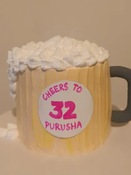 A fun beer mug shaped cake to say "Cheers to 32."