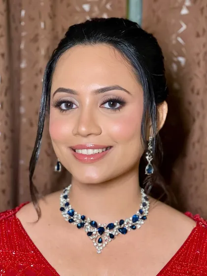 A detailed shot of the soft smoky eye and glossy lip, which let her natural glow shine through.