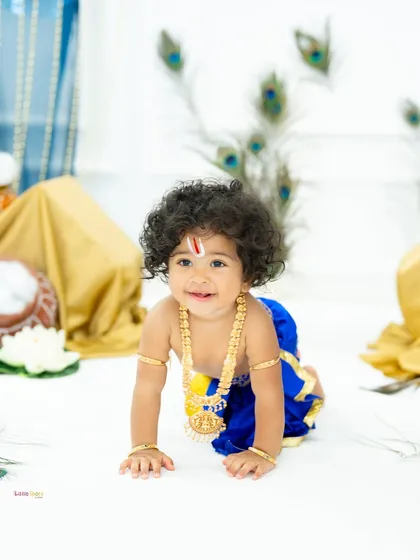 I absolutely adore creating these timeless Little Krishna portraits. This little boy, with his beautiful curly hair and sweet smile, looks divine against the backdrop of peacock feathers, capturing the spirit of Krishna Janmashtami.
