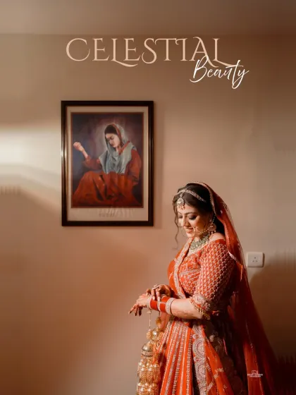 A moment of quiet elegance. The bride, in her beautiful red lehenga, adjusts her bangles, with a classic painting in the background adding to the artistic feel.