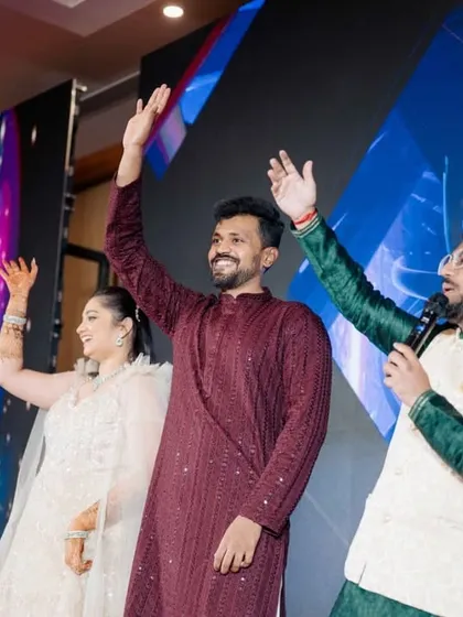 A classic Sangeet moment on stage with the happy couple. My job is to guide the event, create these picture-perfect memories, and ensure the energy never drops.