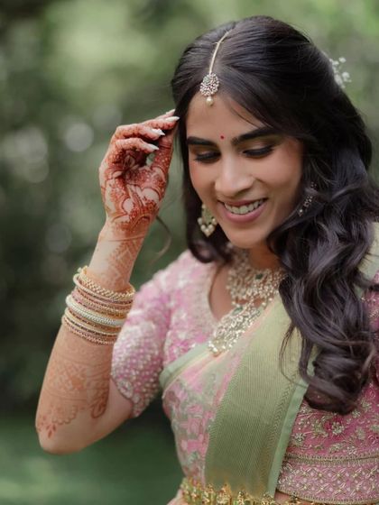 A candid shot of a bride's hands during her engagement ceremony, showing the beautiful henna stain.