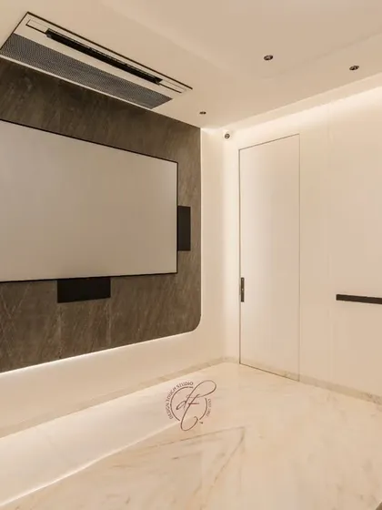 A view of the home theater with the screen off, showcasing the sleek design of the accent wall with integrated LED backlighting. The minimalist aesthetic ensures the focus is on the cinematic experience.