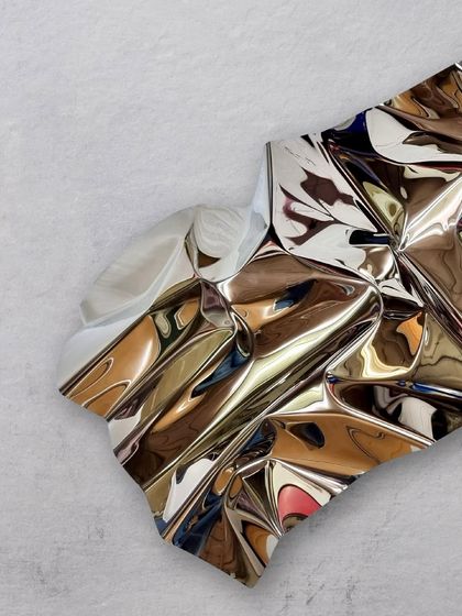 "Meteor 68" is another exploration in pure, polished stainless steel, with a focus on deep, dramatic folds.