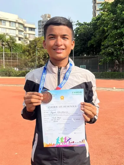Piyush proudly holds up his certificate of honour along with his bronze medal. We ensure our athletes' achievements are formally recognized, building their confidence and portfolio.