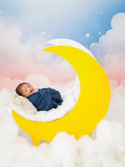 Dreaming on a crescent moon. This whimsical setup is one of many creative options I have in the studio to make your newborn's portraits truly magical.