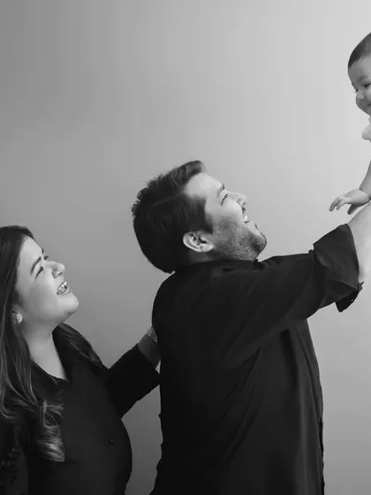 There is a classic, powerful feeling in black and white photography. This shot freezes a moment of pure joy and playfulness, focusing entirely on the family's expressions and the connection between them.
