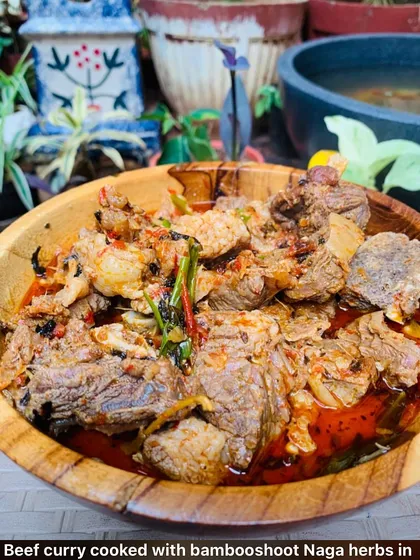 I love making this beef curry. It's cooked slowly with bamboo shoot and special Naga herbs from my garden until the meat is falling apart. The wooden bowl just makes it feel more like home.