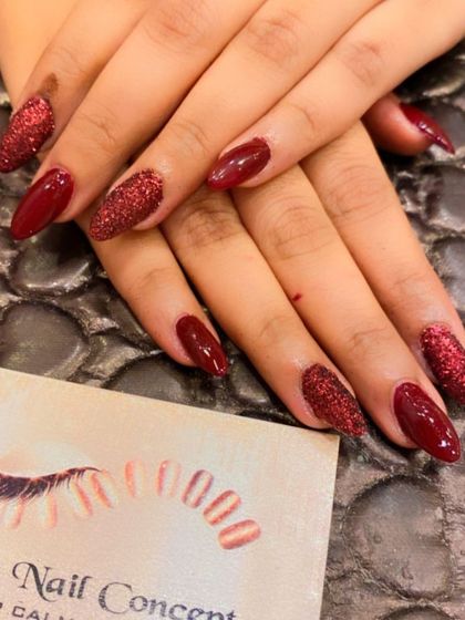 A classic party look with a twist. This set features deep red nails with two accent nails on each hand covered in sparkling red glitter.