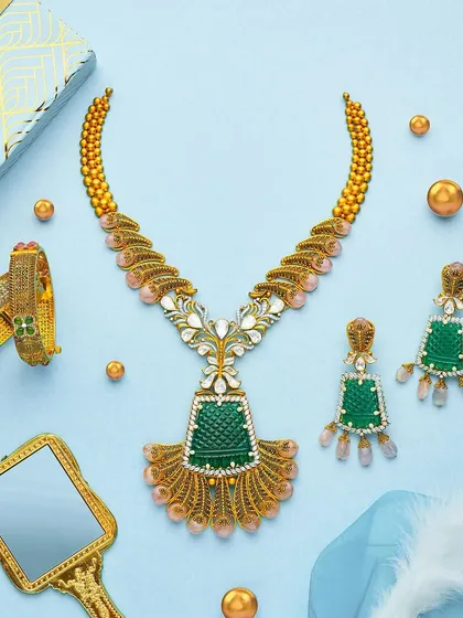 Another stunning set from the PNGadgil summer campaign. The composition is balanced and airy, letting the beautiful green and gold necklace set be the hero while the props add a touch of elegance.