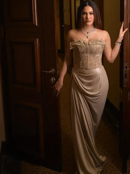 Amyra Dastur standing in a doorway, looking towards the camera. This classic pose is timeless and elegant.