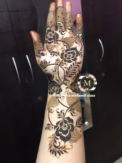 This floral design uses a mix of bold, dark flowers and delicate, shaded leaves.