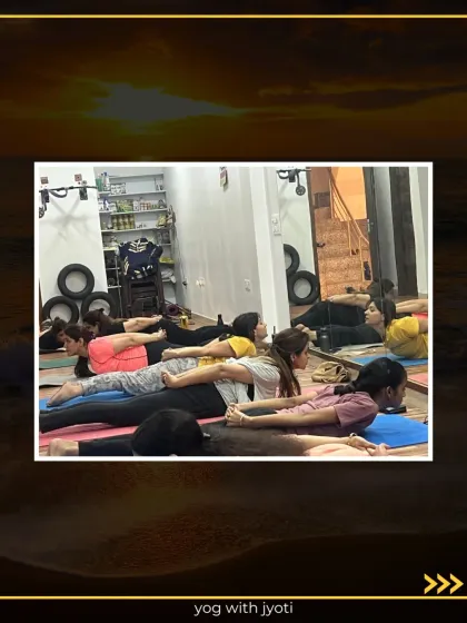 A class practices a variation of Sarpasana with hands clasped behind the back, which provides a deeper chest and shoulder opening.