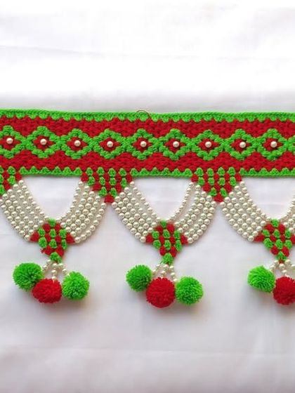 This photo shows the entire length of the 3-foot traditional beaded toran, ready to adorn a doorway.