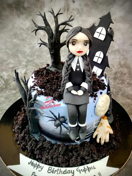 Capturing the wonderfully spooky vibe of Wednesday Addams, this cake was a hit for a fan's birthday. I handcrafted the Wednesday figurine, the haunted house, and even "Thing" to create a memorable and detailed chocolate truffle cake.