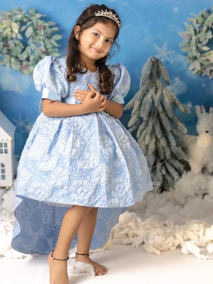 A little girl dressed as Princess Elsa in a magical winter wonderland. This theme is a favorite for Christmas and holiday mini sessions.