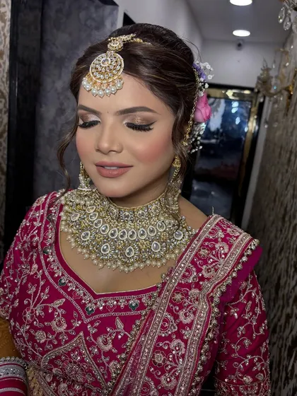 Another angle of this soft glam bridal look. The side-parted hair with floral details adds a modern touch to the overall traditional feel.