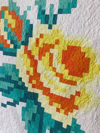 A detail shot of the yellow pixelated rose, highlighting the gradient effect achieved with different fabric tones.