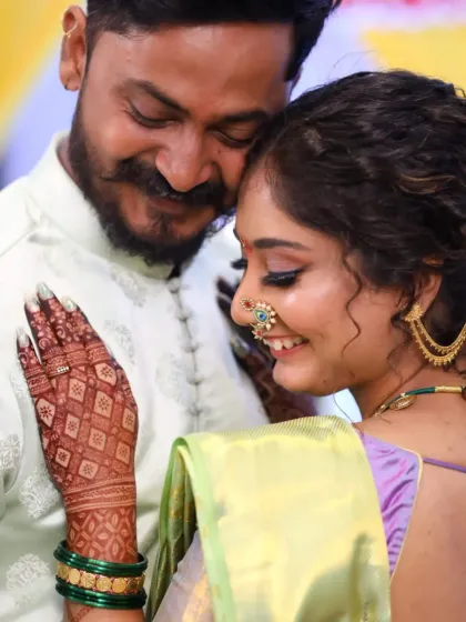 A candid moment from an engagement ceremony, where the bride's beautiful mehendi stain adds to her glow.