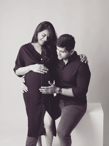 The father to be gently touches the baby bump, his expression full of wonder. In black and white, this simple gesture becomes a powerful symbol of his budding connection with his child.