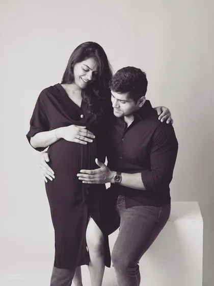 The father to be gently touches the baby bump, his expression full of wonder. In black and white, this simple gesture becomes a powerful symbol of his budding connection with his child.