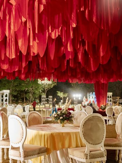 A close-up of the stunning red petal ceiling installation, a unique and dramatic element that defines the entire space.