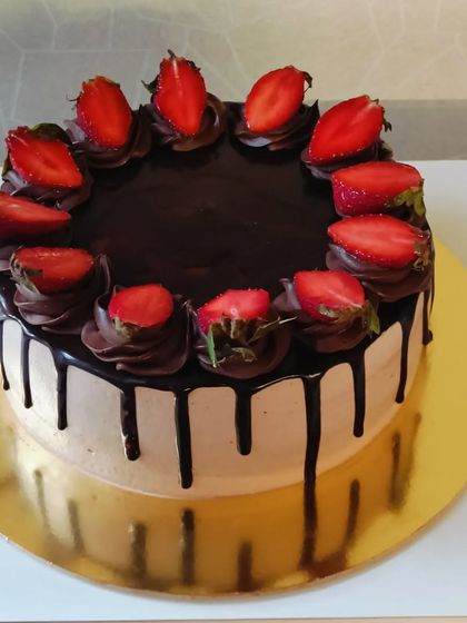 A classic chocolate drip cake topped with fresh, juicy strawberries. The combination of rich chocolate and tart berries is always a winner.