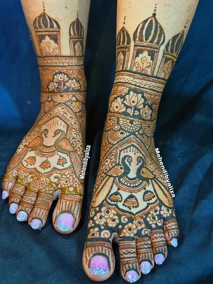 Bridal feet mehendi featuring palace architecture and peacocks. The design is intricate and elegant, perfect for a royal bridal look.