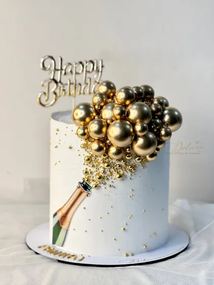Celebrate in style with this chic champagne-themed cake. A cascade of golden bubbles, made from chocolate, bursts from an edible print of a champagne bottle. It's a modern and sophisticated design, perfect for birthdays, anniversaries, or any big milestone.