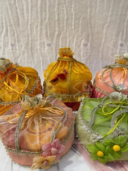 A collection of my special Ghewar packaging for Teej. These colorful, decorated 'potlis' are a crowd favorite, adding an extra layer of beauty to the traditional sweet.