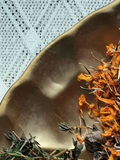 A close-up of dried calendula petals and other herbs. I love using botanicals not just for their benefits, but also for the natural beauty they add to my products.