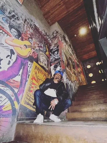 Squatting low, but the vibe is high. Another shot from the graffiti wall, representing the street culture of hip-hop.