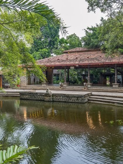 The Pond Pavilion viewed from across the Kalyani, with the water fountain adding movement and life to the serene scene.