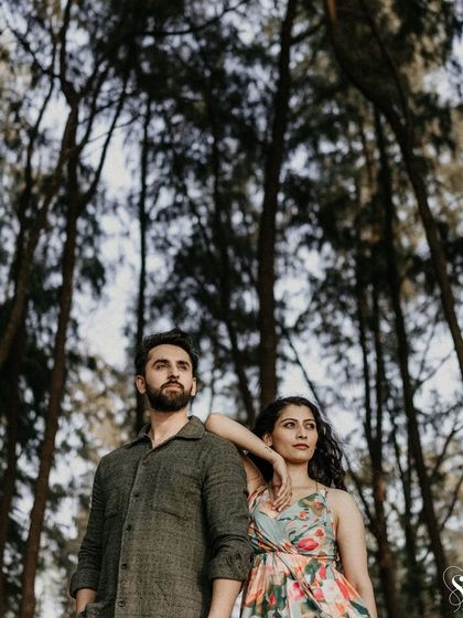 A striking pose among the tall trees. This shot uses the vertical lines of the forest to create a powerful and artistic portrait that feels both grand and intimate.