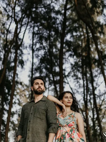 A striking pose among the tall trees. This shot uses the vertical lines of the forest to create a powerful and artistic portrait that feels both grand and intimate.