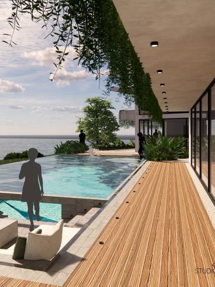 The expansive wooden deck at the Pai Residence runs along the glass facade of the house, blurring the line between indoors and outdoors. The infinity pool's edge merges with the horizon of the Gurupura river, creating a spectacular visual effect.
