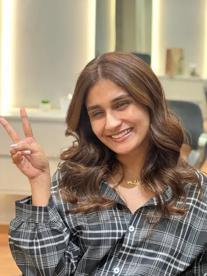 A happy client with her new beige brown balayage. The color is soft, subtle, and perfectly complements her style.