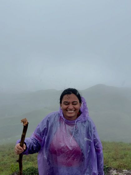 A trekker with a happy smile, enjoying the misty weather on the Gangadikal trek.